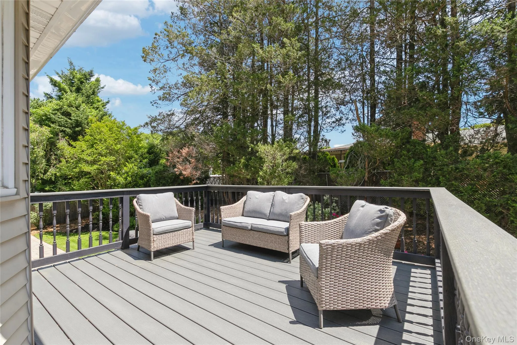 Expansive outdoor deck featuring composite decking and dark railings Expansive outdoor deck featuring composite decking and dark railings
