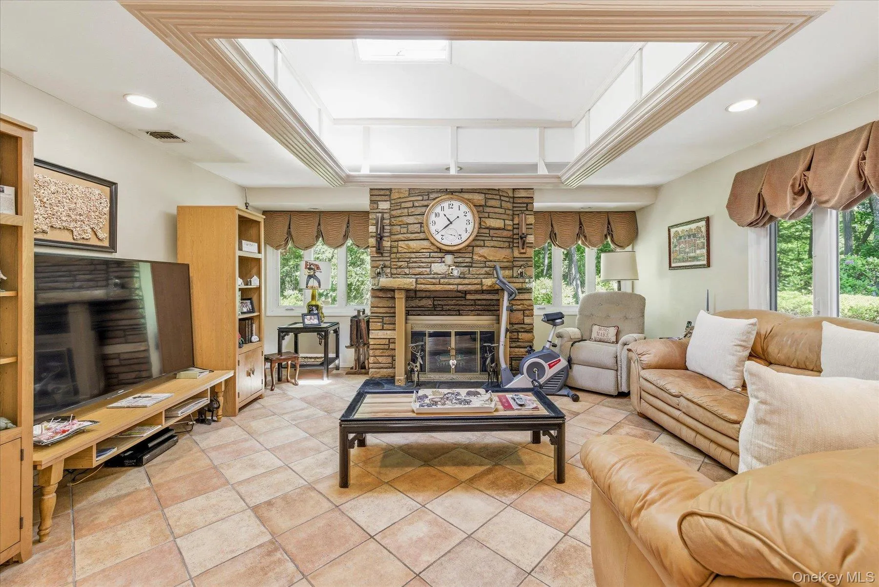 Family room with wood burning fireplace and skylight Family room with wood burning fireplace and skylight