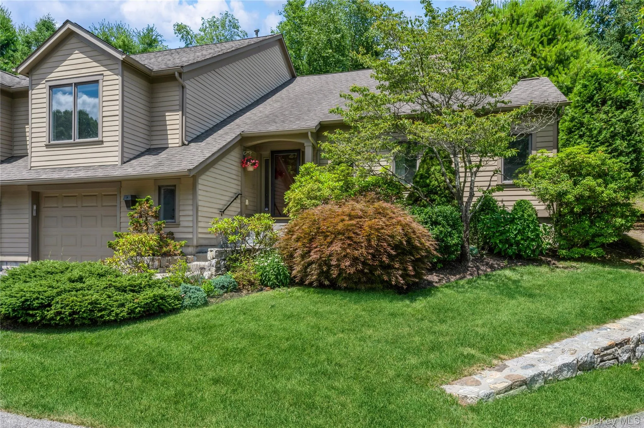 View of front facade with a garage, a shingled roof, and a front yard View of front facade with a garage, a shingled roof, and a front yard