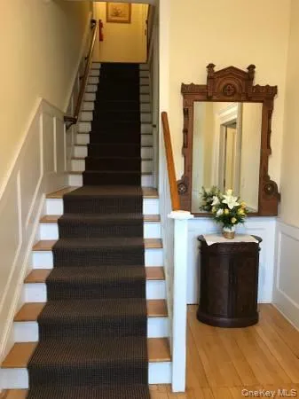Stairs with a wainscoted wall, a decorative wall, and wood finished floors Stairs with a wainscoted wall, a decorative wall, and wood finished floors