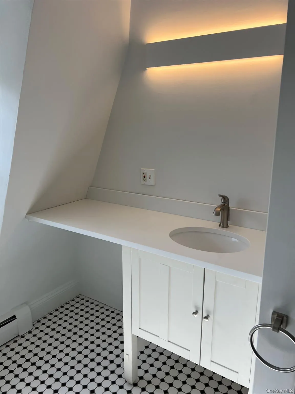 Bathroom featuring a baseboard radiator and a sink Bathroom featuring a baseboard radiator and a sink