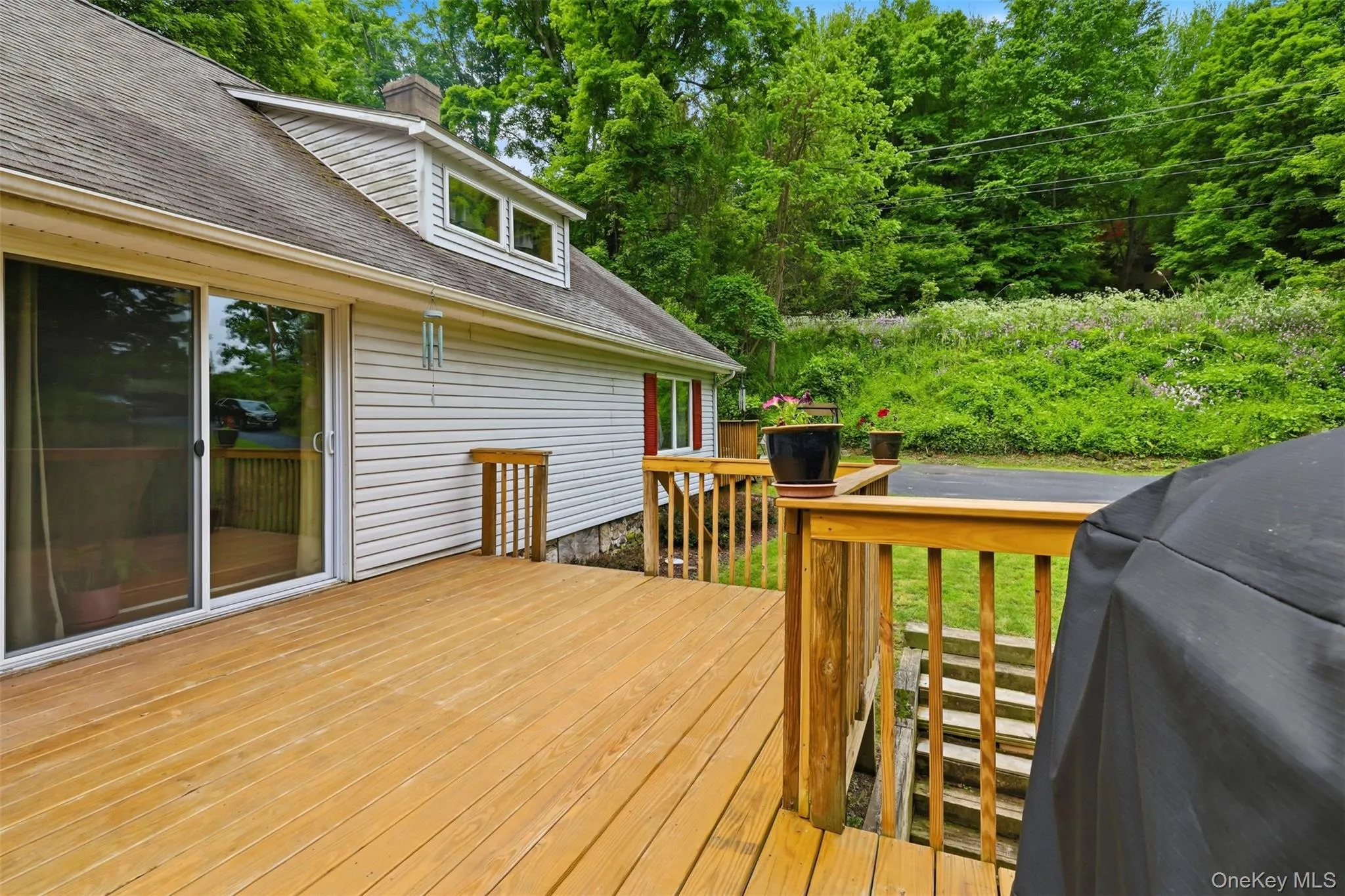 Expansive wood deck featuring a natural finish with sliders to living room Expansive wood deck featuring a natural finish with sliders to living room