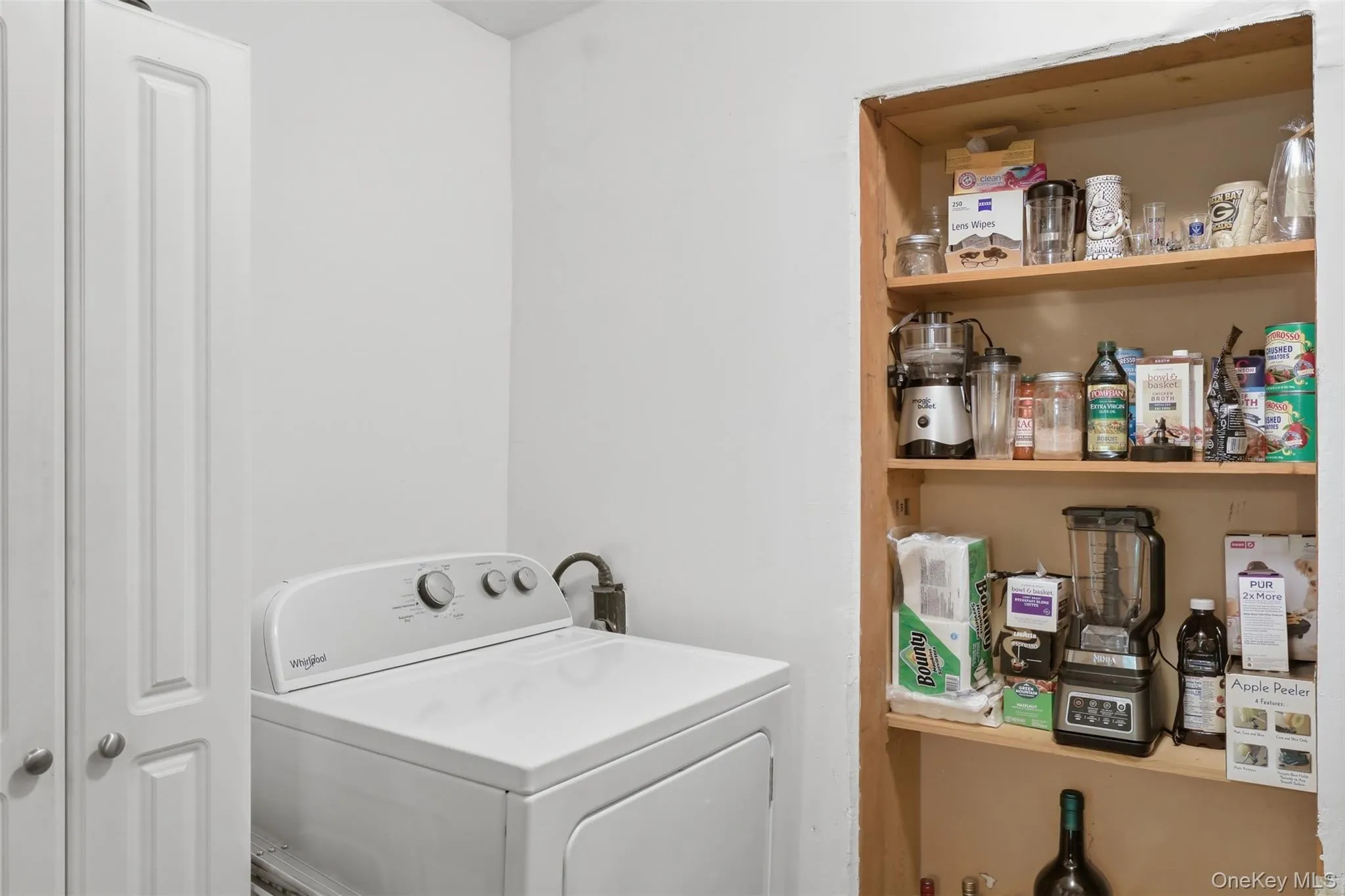 Dedicated utility area featuring a washer & dryer(may not convey) and shelves for pantry storage Dedicated utility area featuring a washer & dryer(may not convey) and shelves for pantry storage