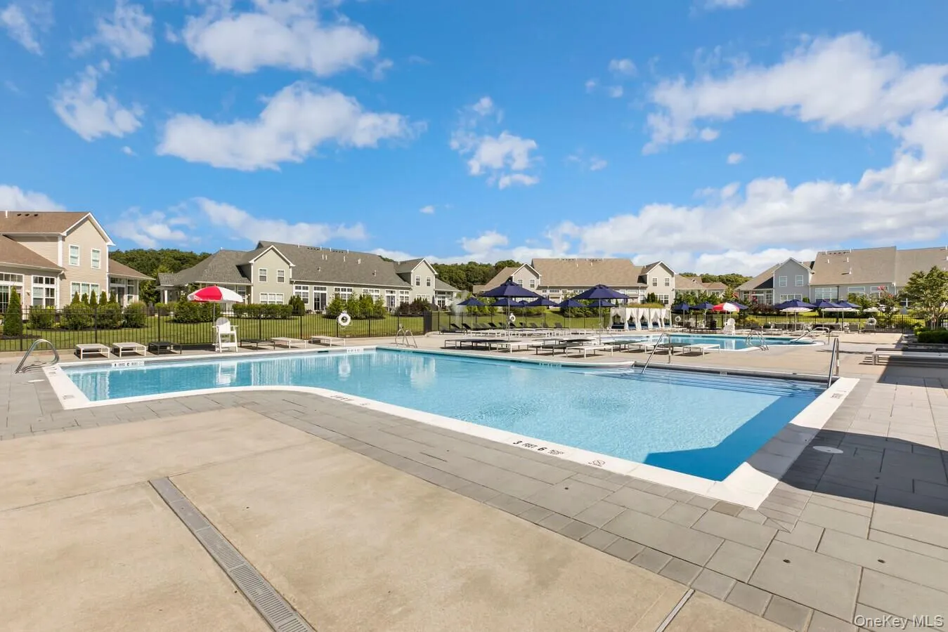 Community pool with a residential view and a patio Community pool with a residential view and a patio