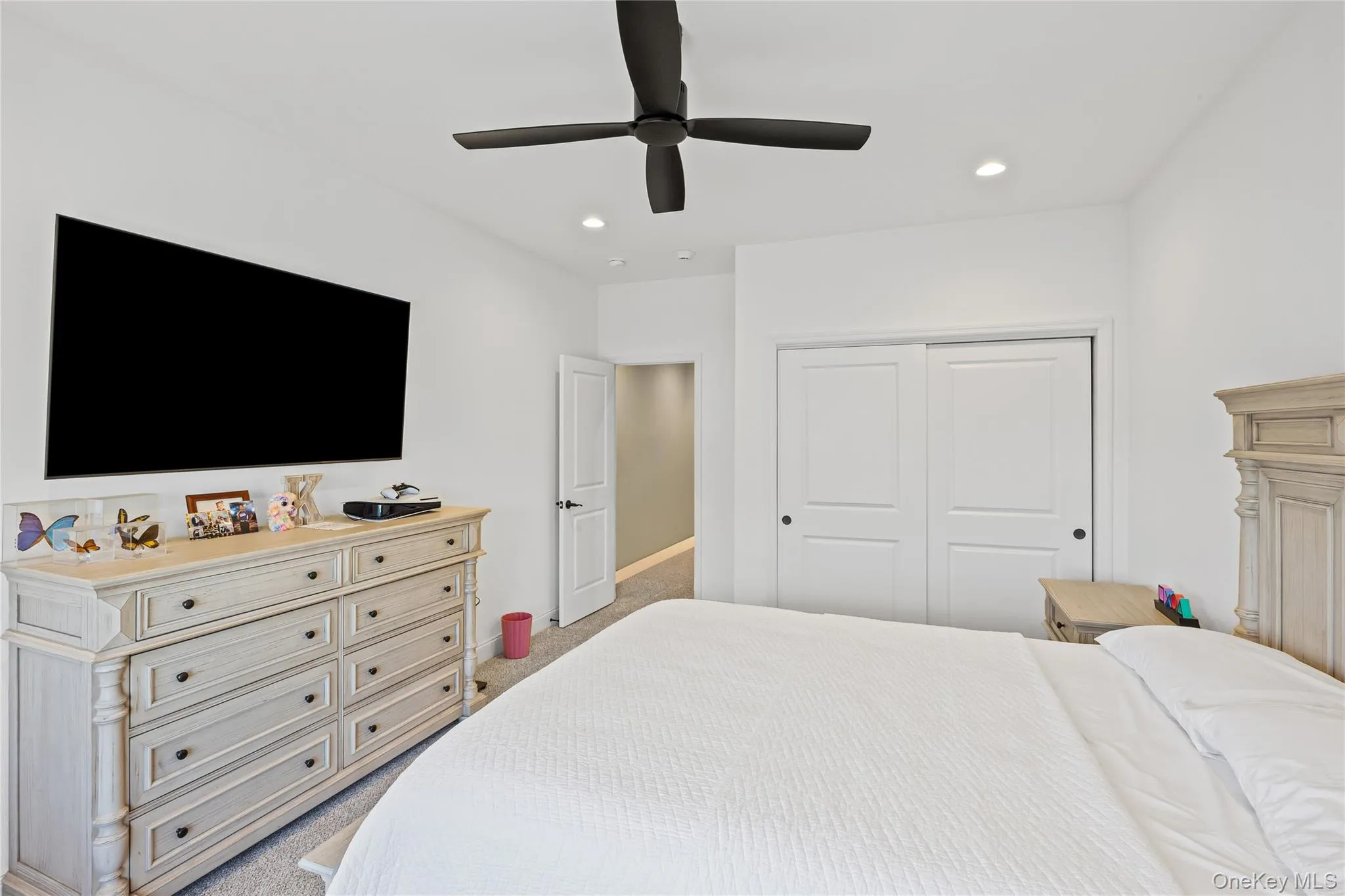 Bedroom featuring light carpet, ceiling fan, recessed lighting, and a closet Bedroom featuring light carpet, ceiling fan, recessed lighting, and a closet