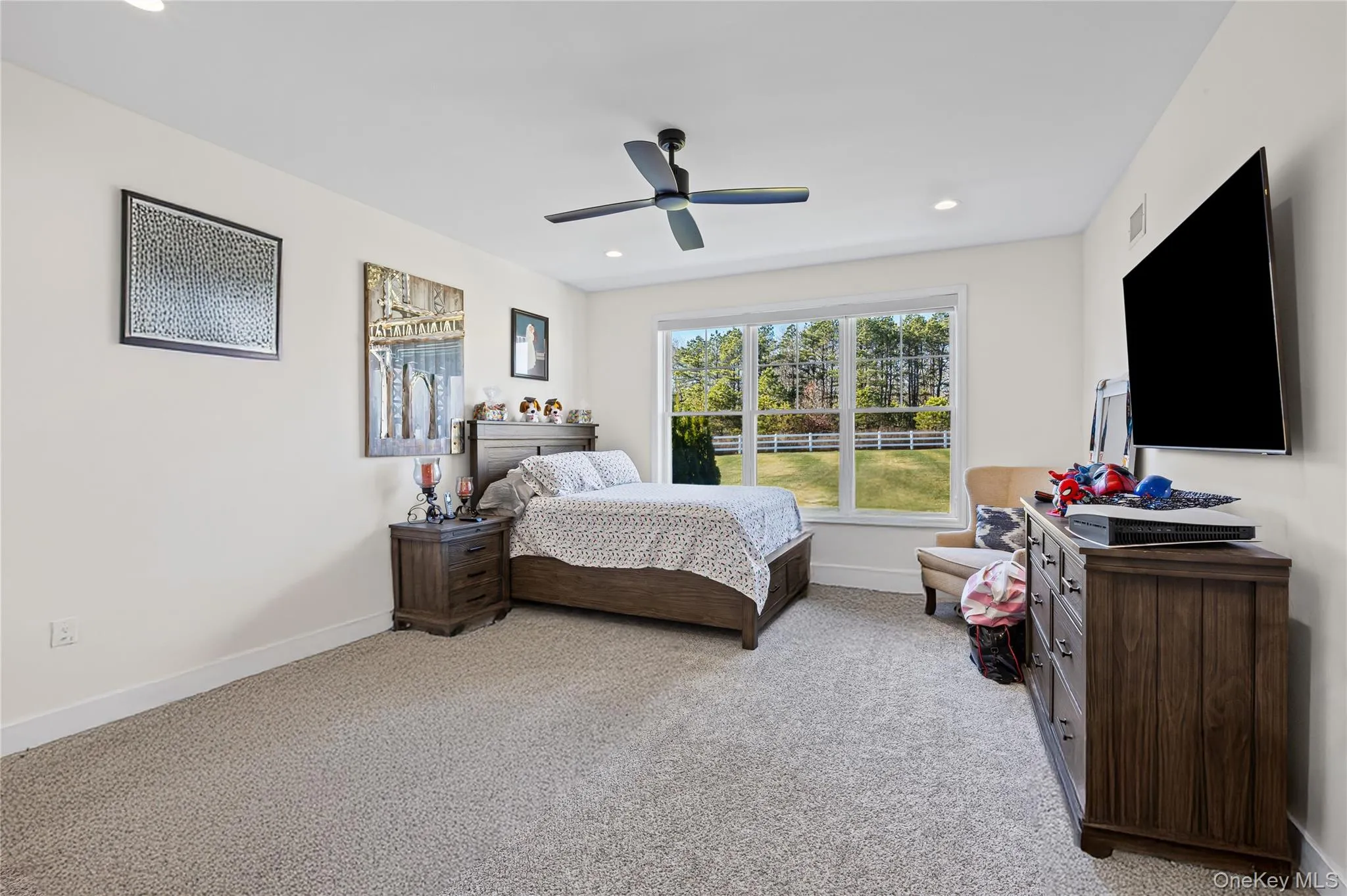 Bedroom with light colored carpet, a ceiling fan, and recessed lighting Bedroom with light colored carpet, a ceiling fan, and recessed lighting