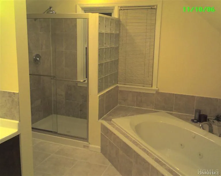 A glass block wall separates the frameless glass shower from the spa tub with marble-surround. Lighting has been upgraded with energy-efficient recessed LED retrofit kits. The private master suite, consisting of the master bedroom and this master bath occupy the entire second floor. A glass block wall separates the frameless glass shower from the spa tub with marble-surround. Lighting has been upgraded with energy-efficient recessed LED retrofit kits. The private master suite, consisting of the master bedroom and this master bath occupy the entire second floor.