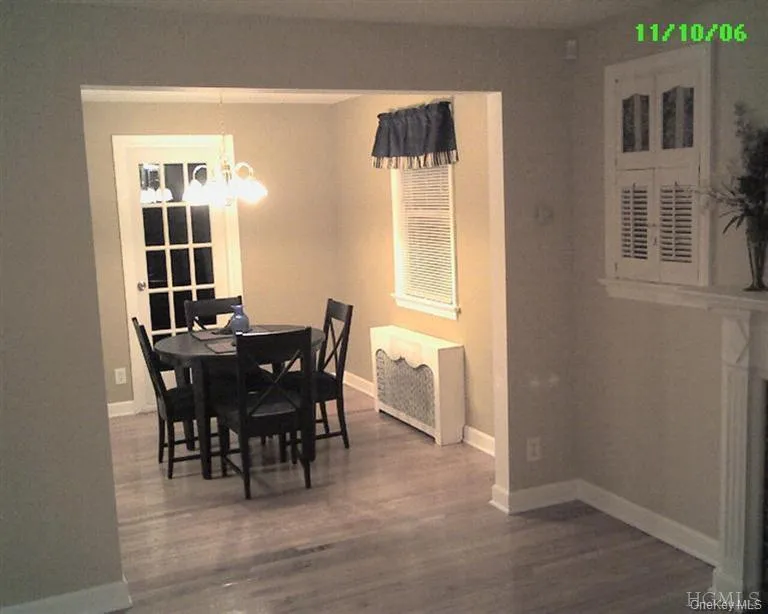Dining room with new (2013) hardwood floors and a French door to patio and fenced yard Dining room with new (2013) hardwood floors and a French door to patio and fenced yard