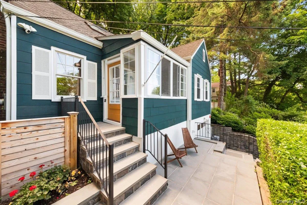 Front stone patio with access to side yard. Front stone patio with access to side yard.