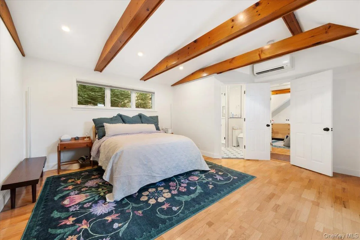 Second floor primary bedroom with tons of natural light, sky light and wooden beamed ceilings. Second floor primary bedroom with tons of natural light, sky light and wooden beamed ceilings.
