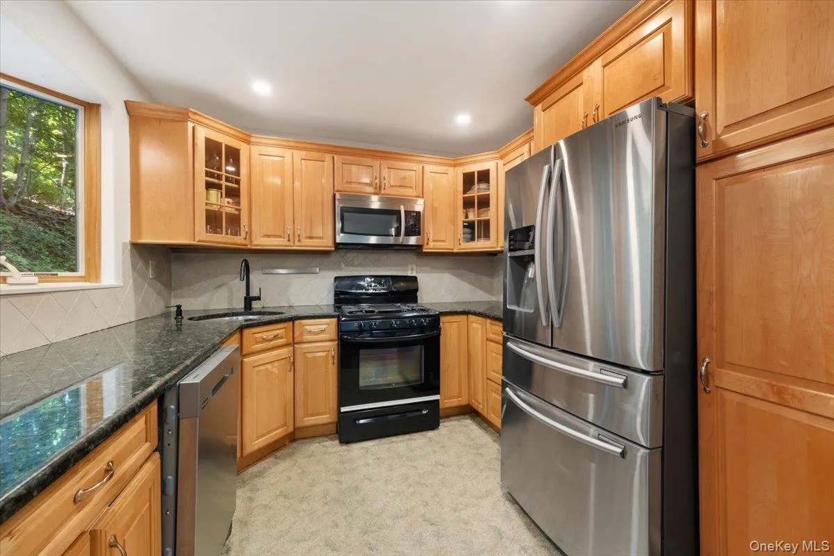 Well-appointed kitchen with granite counters, stainless steel appliances and ample storage. Well-appointed kitchen with granite counters, stainless steel appliances and ample storage.
