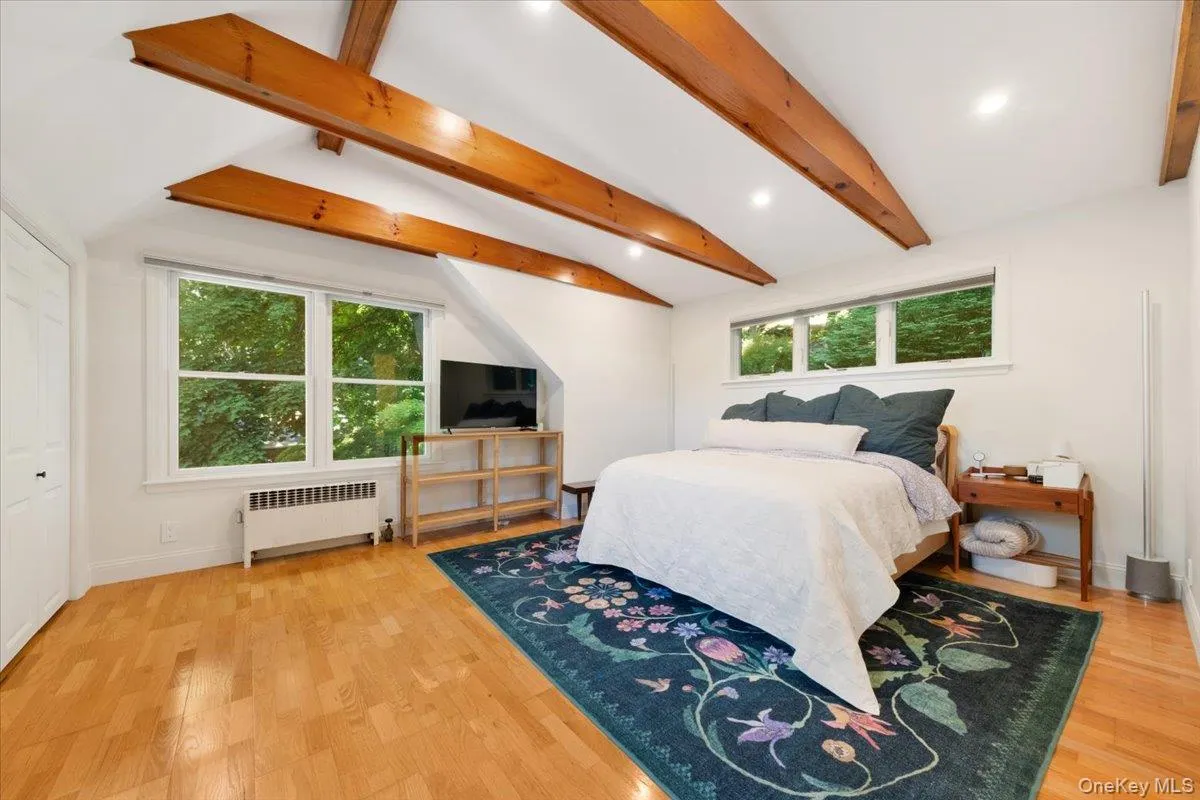 Second floor primary bedroom with tons of natural light, sky light and wooden beamed ceilings. Second floor primary bedroom with tons of natural light, sky light and wooden beamed ceilings.