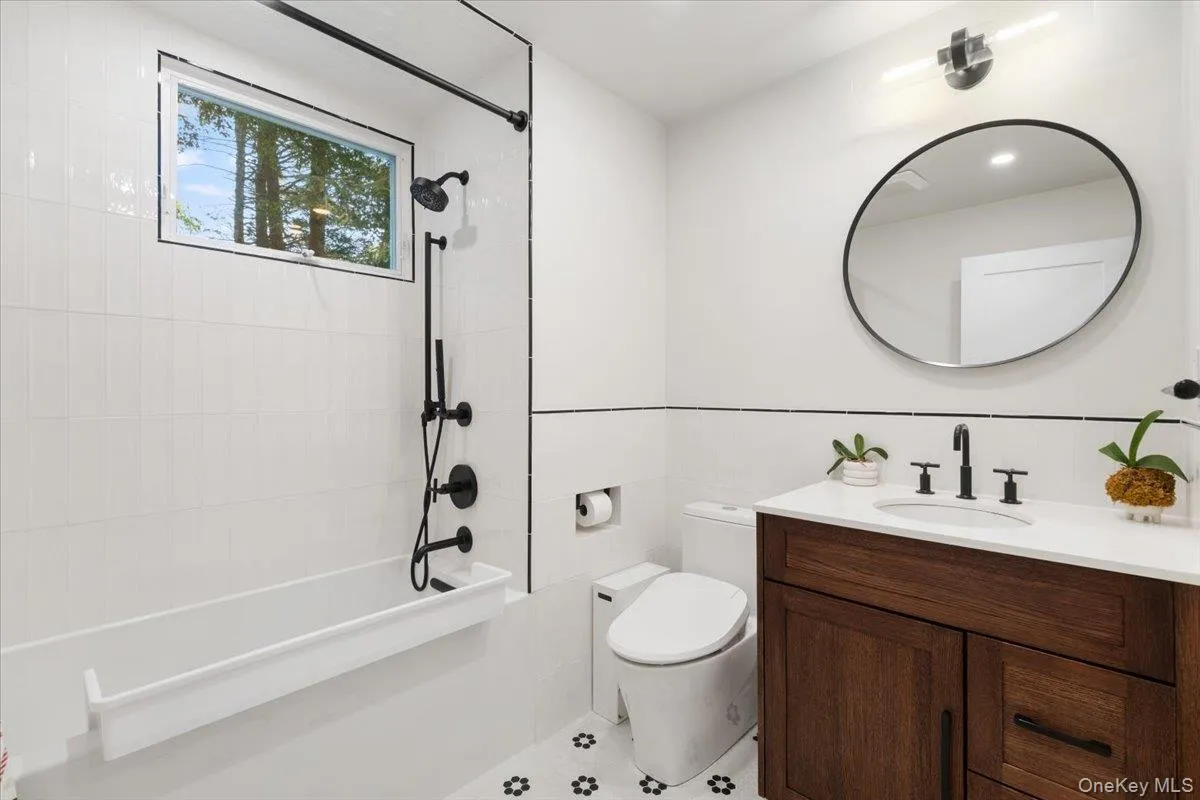 Updated first floor hall bath with soaking tub and heated floors. Updated first floor hall bath with soaking tub and heated floors.