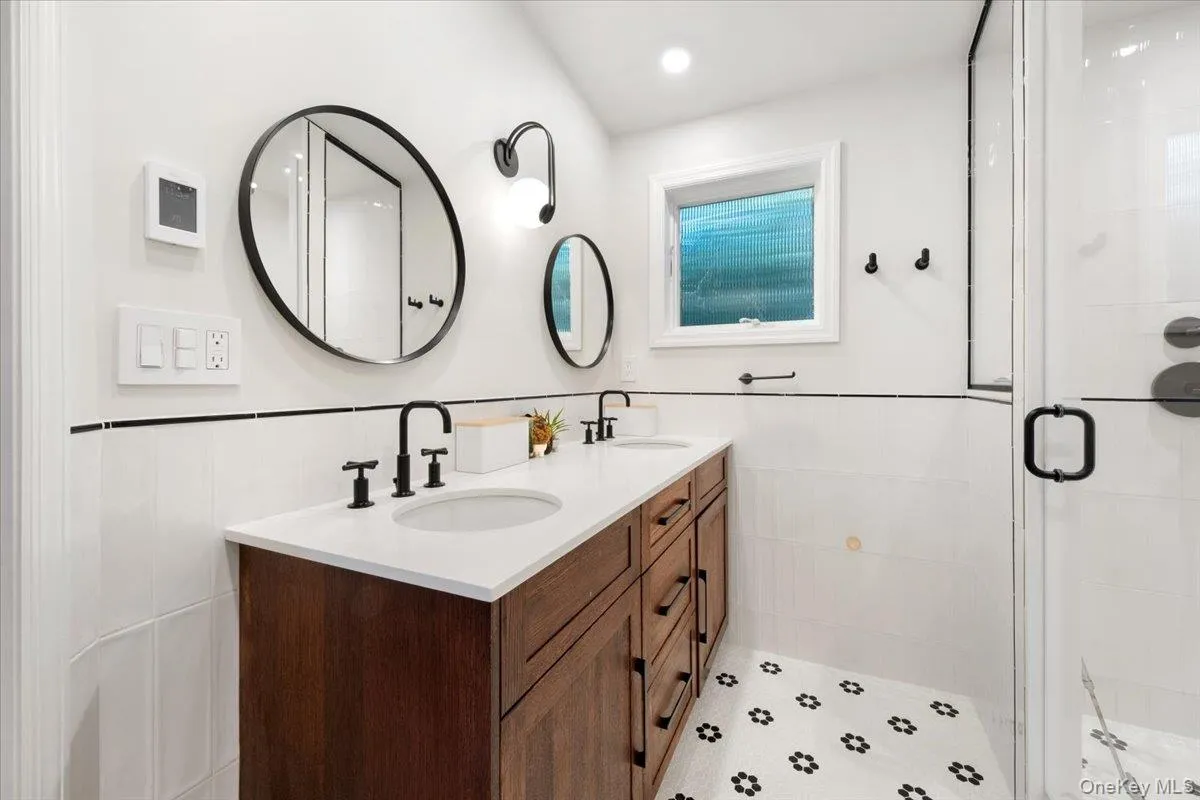 Updated primary bathroom with double vanity and spa shower. Updated primary bathroom with double vanity and spa shower.