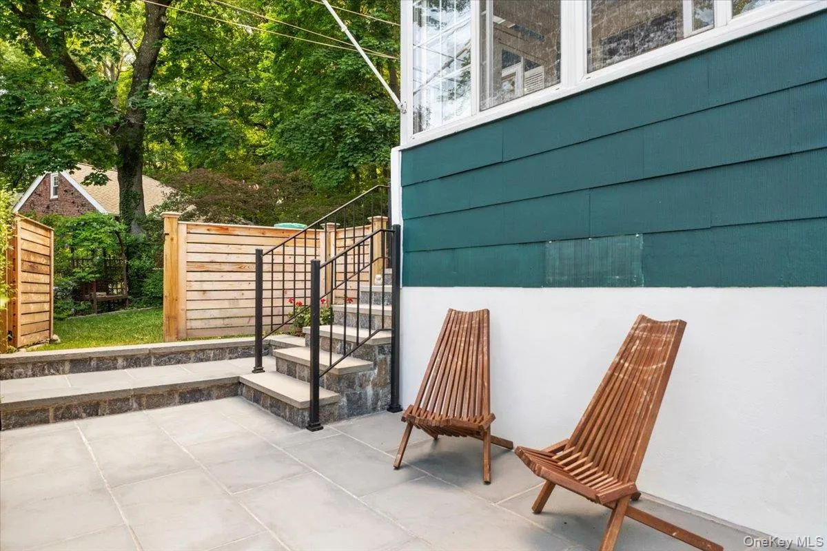 Front stone patio with access to side yard. Front stone patio with access to side yard.