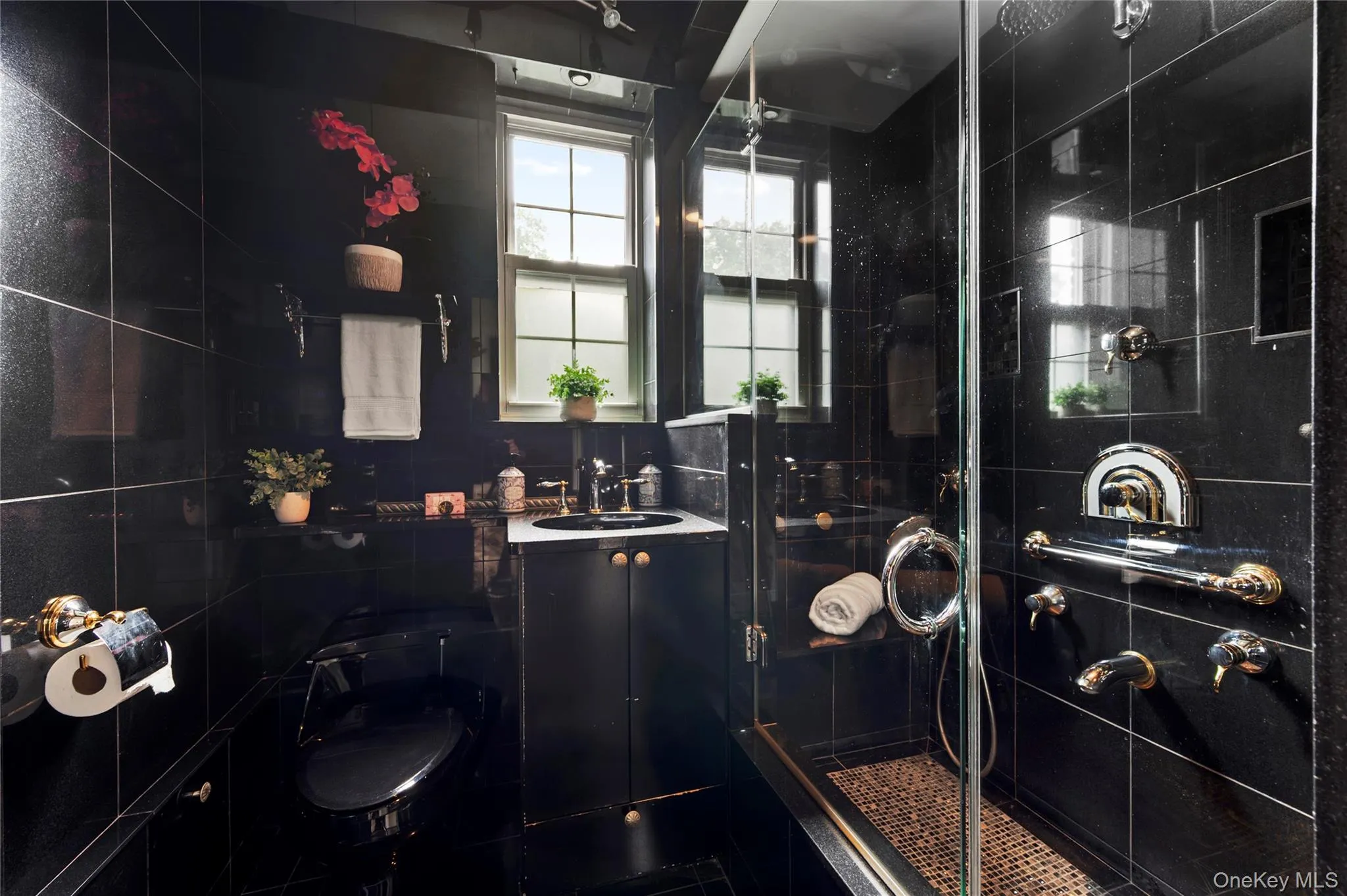 Enjoy the convenience of a stand-up shower with versatile spray options in this thoughtfully designed bathroom Enjoy the convenience of a stand-up shower with versatile spray options in this thoughtfully designed bathroom