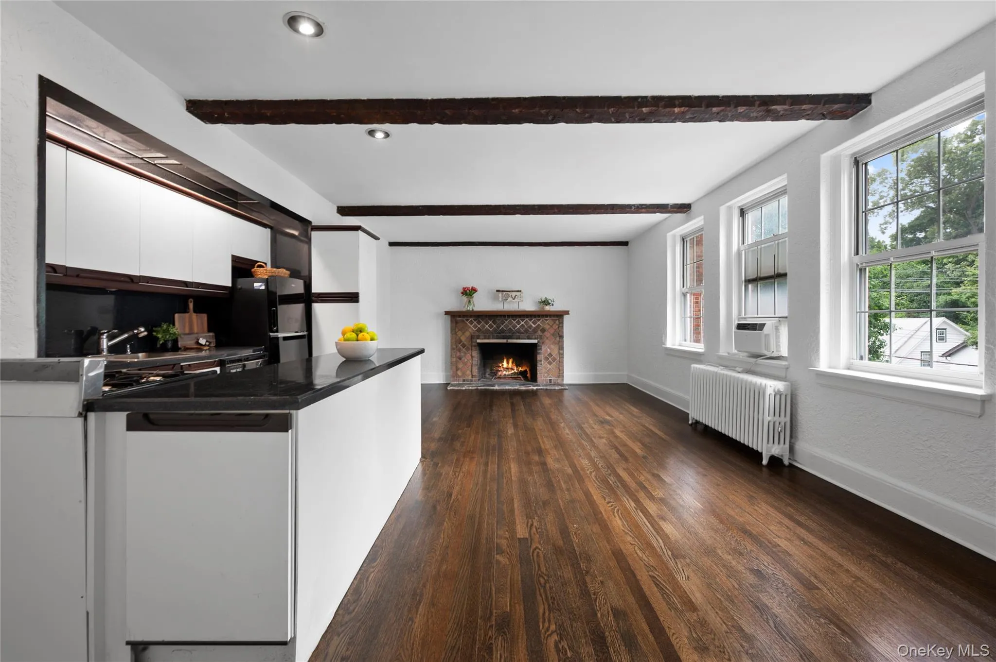 Beautifully refinished hardwood floors blend seamlessly with the beam details, offering a fresh, modern feel while preserving the charm of the original architecture Beautifully refinished hardwood floors blend seamlessly with the beam details, offering a fresh, modern feel while preserving the charm of the original architecture