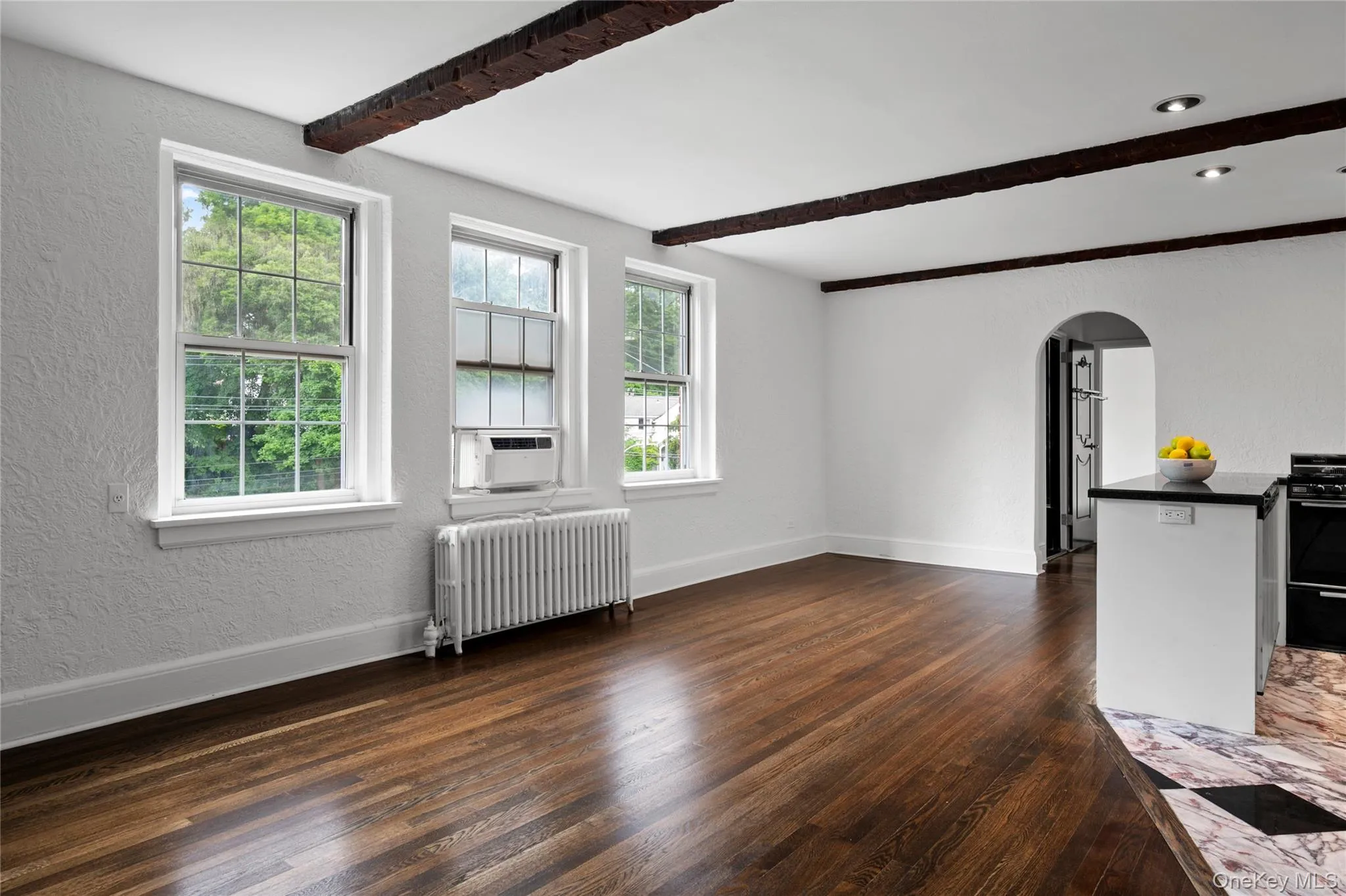 Three generously sized windows fill the unit with abundant natural light, creating a bright and welcoming atmosphere Three generously sized windows fill the unit with abundant natural light, creating a bright and welcoming atmosphere