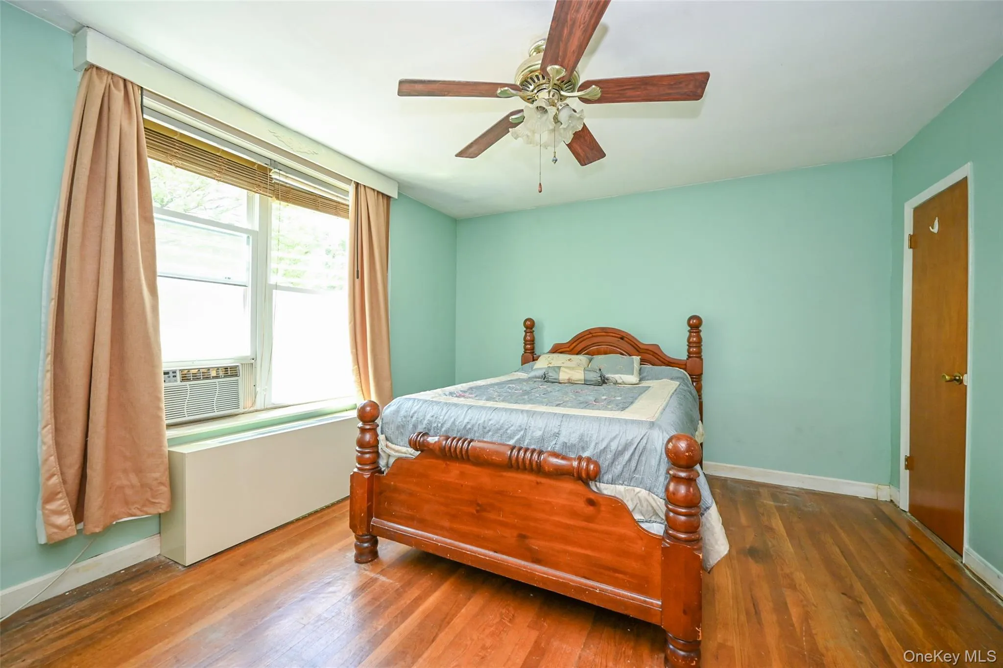 Spacious primary bedroom with pre-engineered hardwood flooring. Spacious primary bedroom with pre-engineered hardwood flooring.