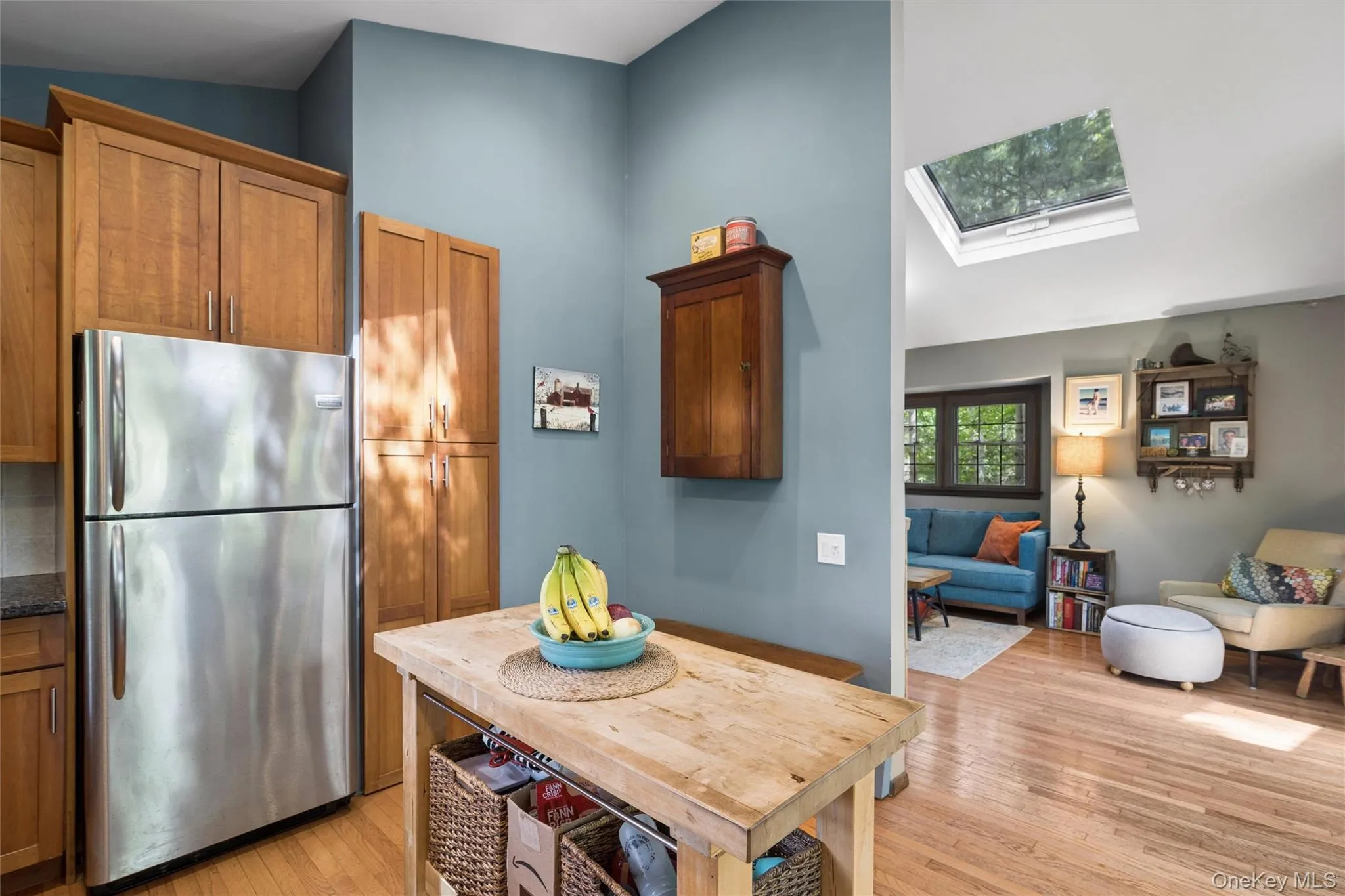 Kitchen area featuring wood-finish cabinetry, stainless steel refrigerator, and a wood-top island Kitchen area featuring wood-finish cabinetry, stainless steel refrigerator, and a wood-top island