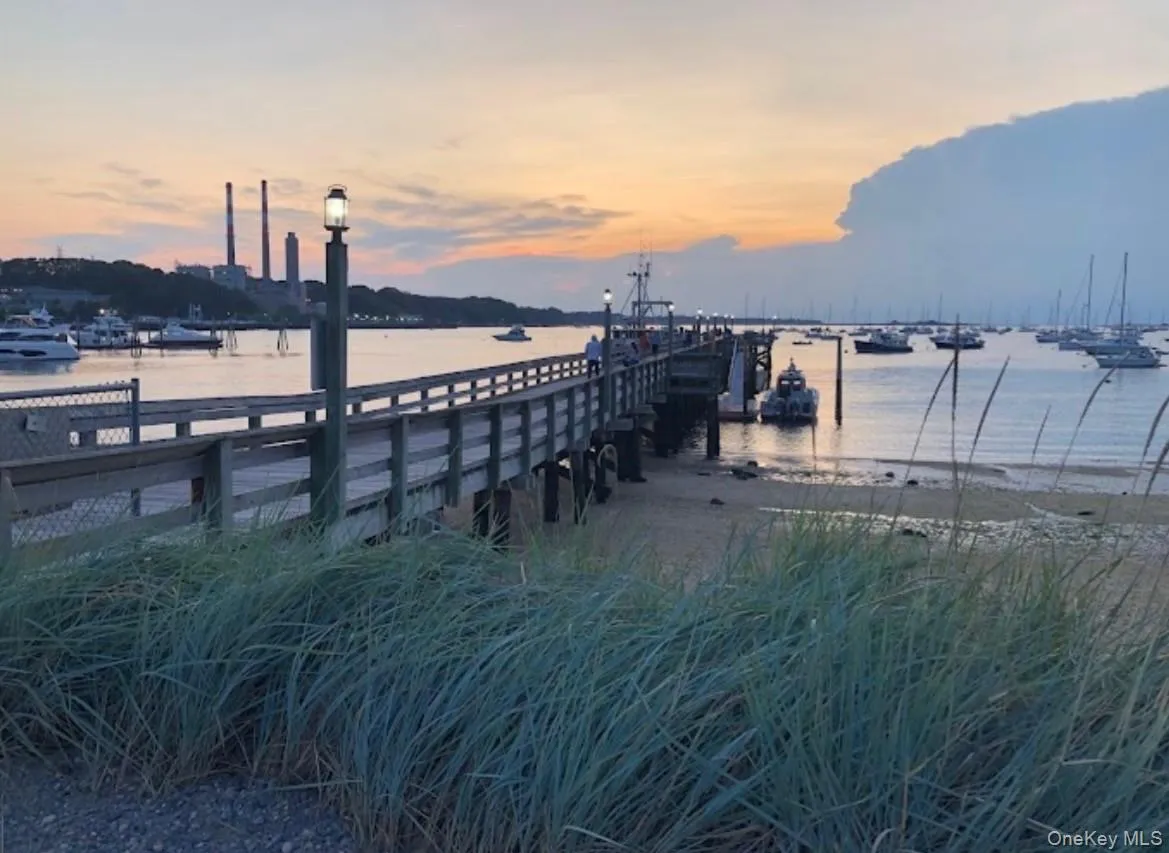 Port Jeff Village 10 mins away! Wooden pier extending into a calm body of water with multiple boats moored Port Jeff Village 10 mins away! Wooden pier extending into a calm body of water with multiple boats moored
