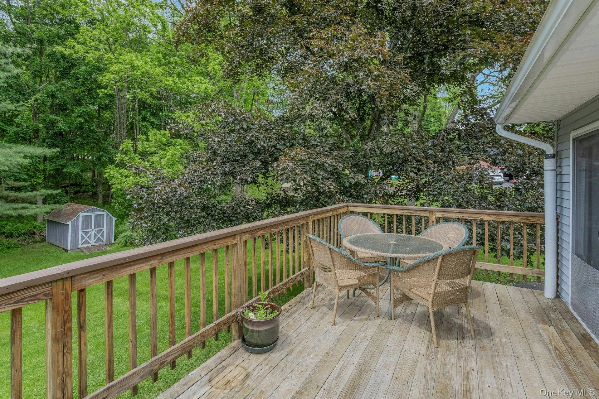 Expansive wood deck with a natural finish, featuring a wood railing Expansive wood deck with a natural finish, featuring a wood railing