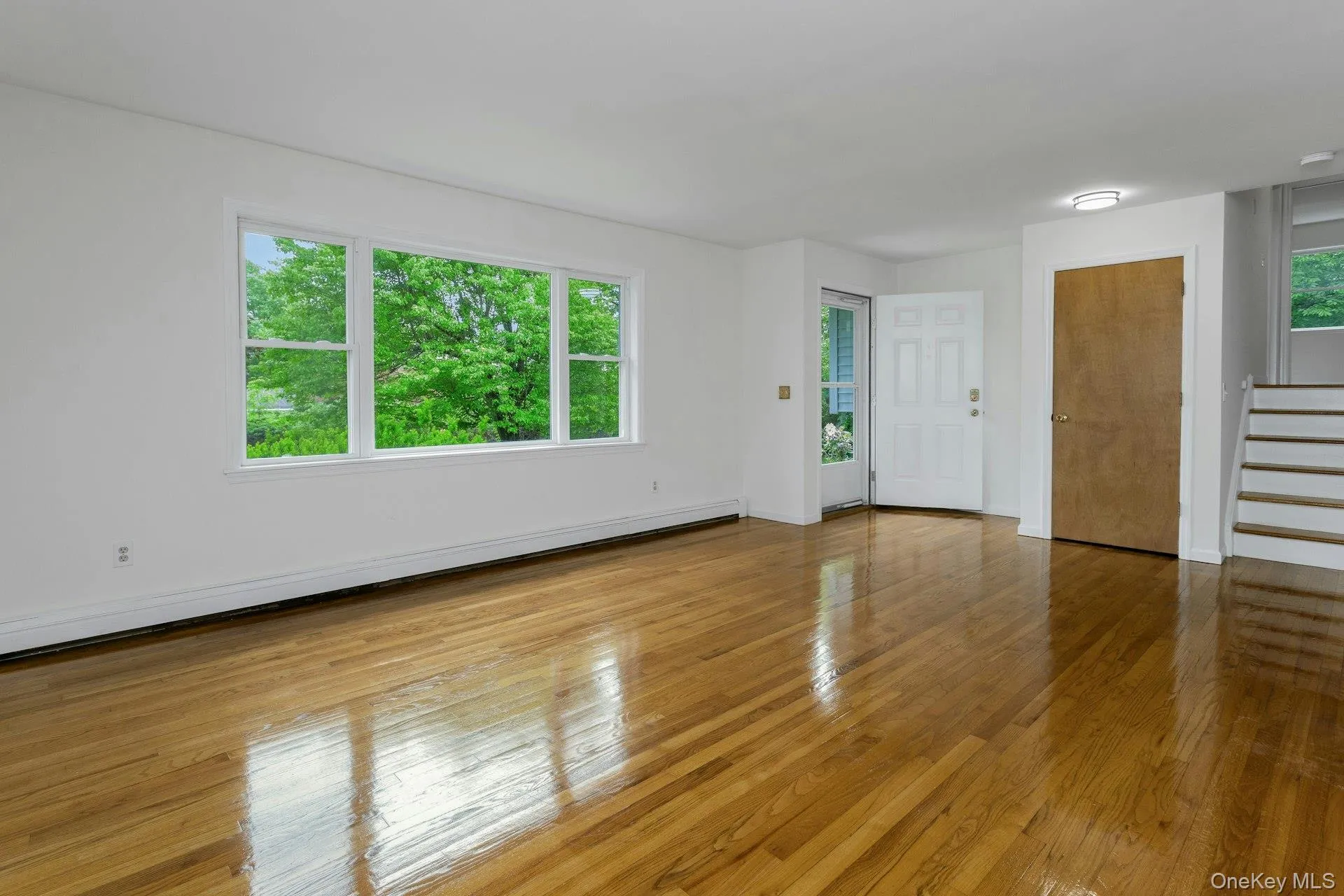 Large Living Room with newly finished wood floors. Large Living Room with newly finished wood floors.