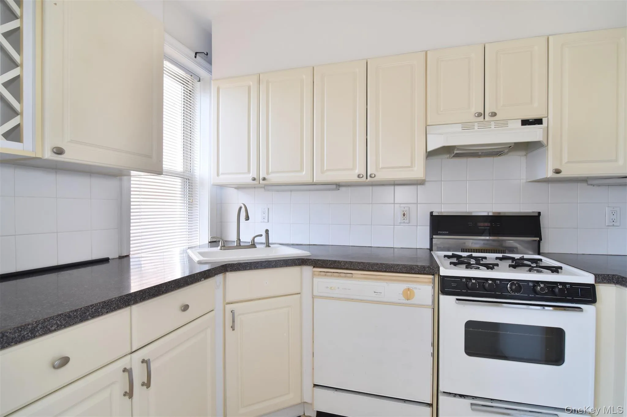 Cozy and functional, the kitchen is thoughtfully outfitted with a good amount of cabinetry and ample counter space for everyday cooking and storage. Cozy and functional, the kitchen is thoughtfully outfitted with a good amount of cabinetry and ample counter space for everyday cooking and storage.