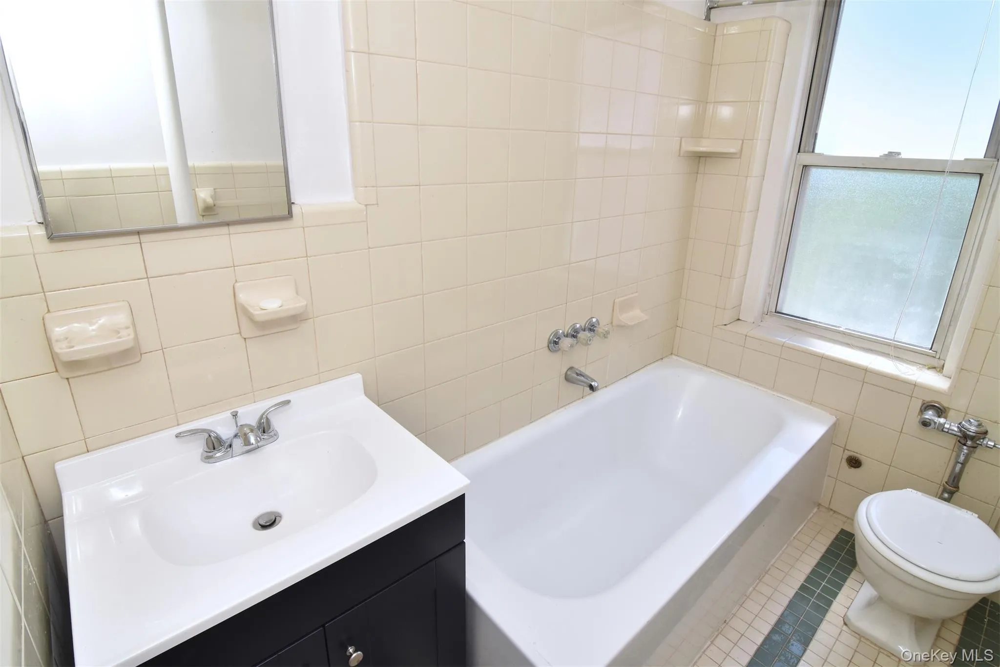 A full bath with a new vanity completes the apartment's inviting interior. A full bath with a new vanity completes the apartment's inviting interior.