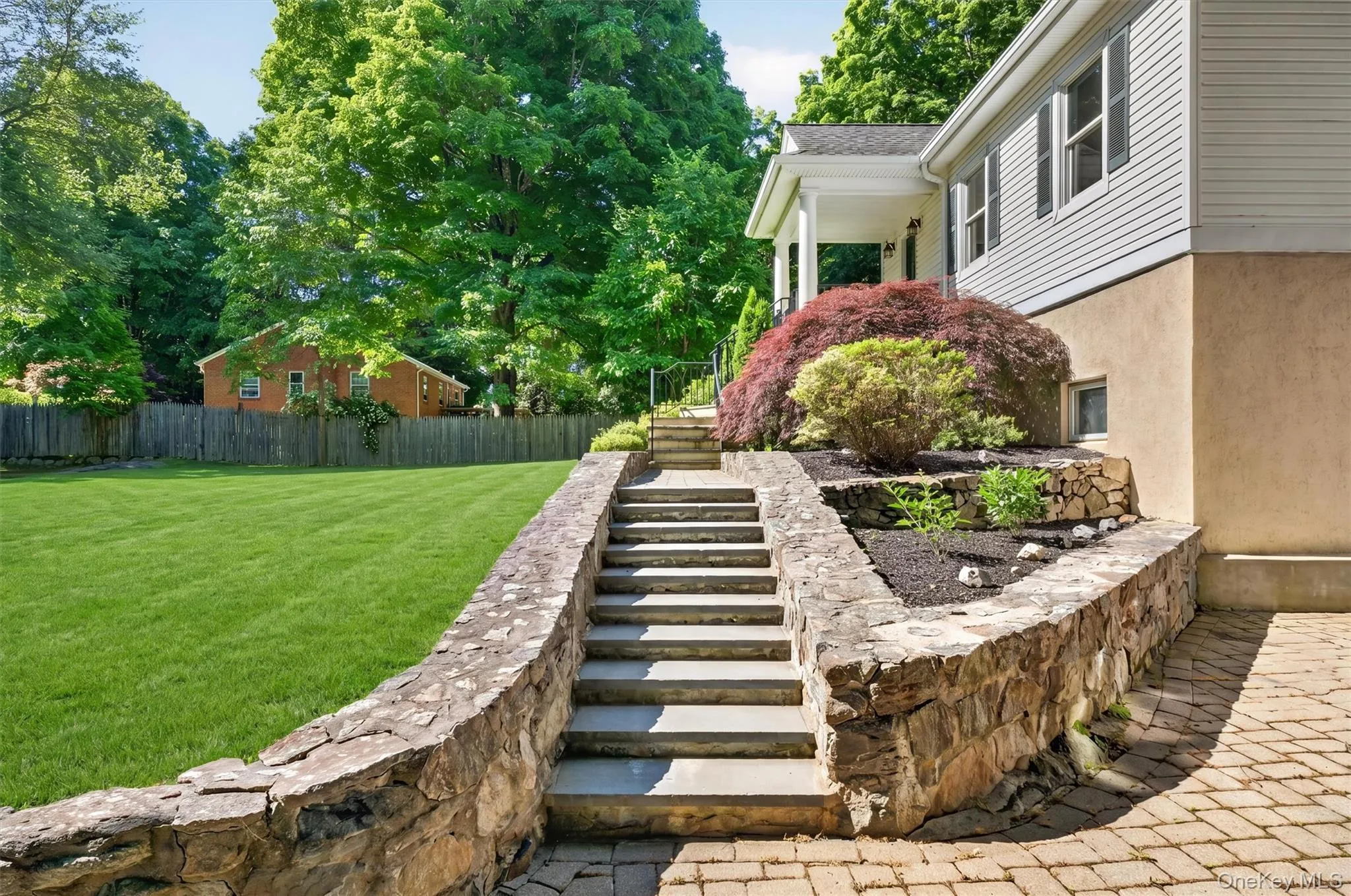 Beautiful stonework accents the landscaped grounds & welcoming front porch. Beautiful stonework accents the landscaped grounds & welcoming front porch.