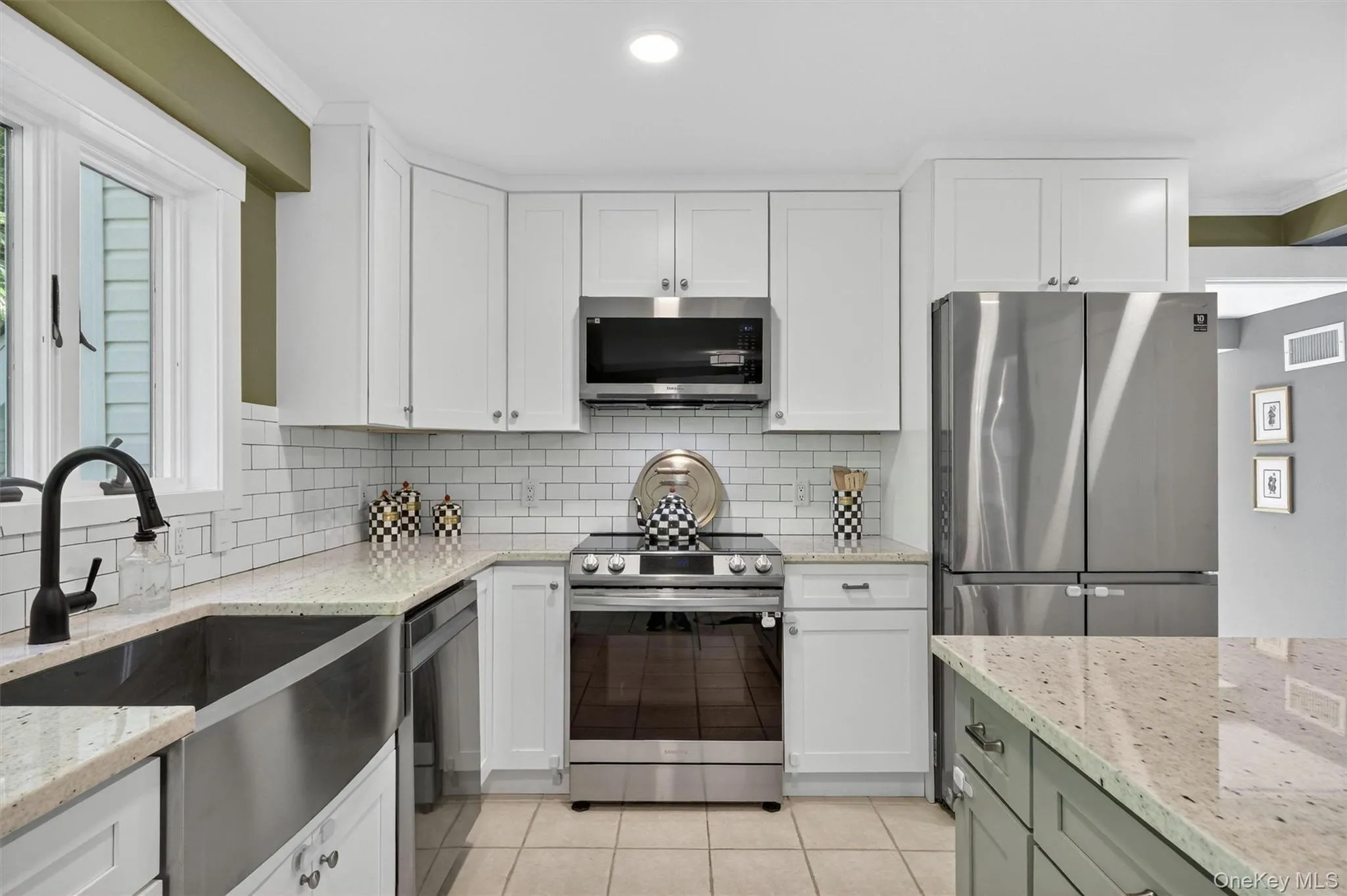 Kitchen boasts stainless steel appliances and a classic farmhouse sink. Kitchen boasts stainless steel appliances and a classic farmhouse sink.