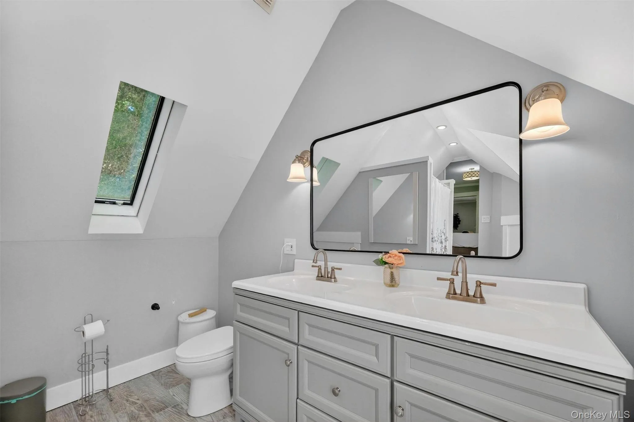 Double sink vanity & skylight fill the space with comfort & natural light. Double sink vanity & skylight fill the space with comfort & natural light.
