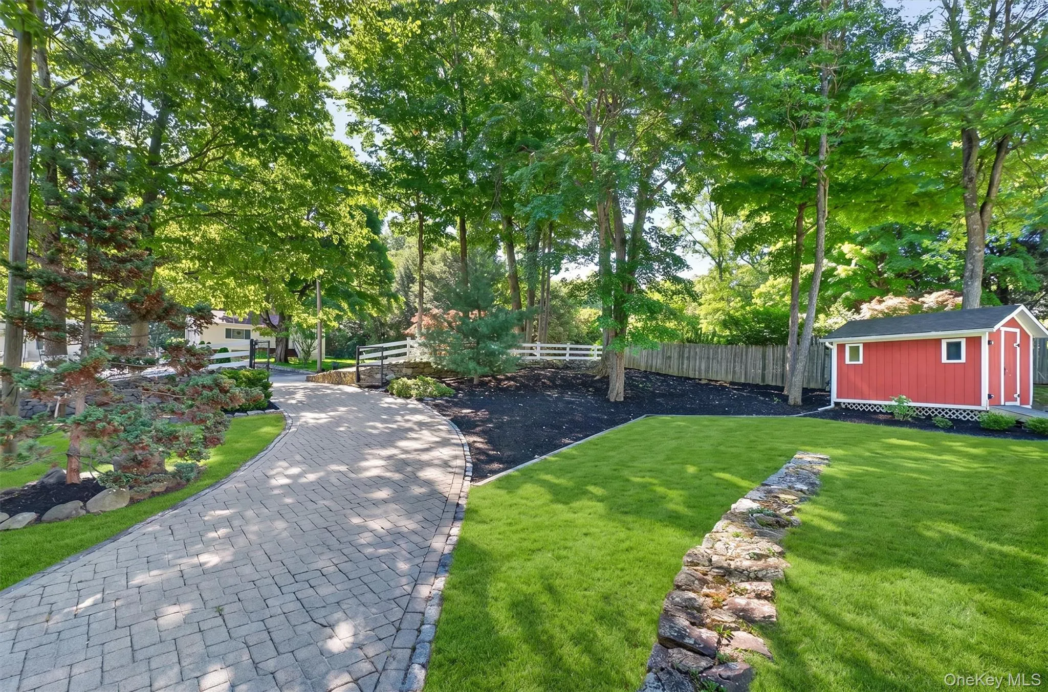 Winding paver driveway & storage shed. Winding paver driveway & storage shed.