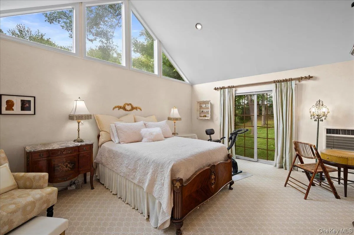 Spacious primary bedroom with view of backyard Spacious primary bedroom with view of backyard