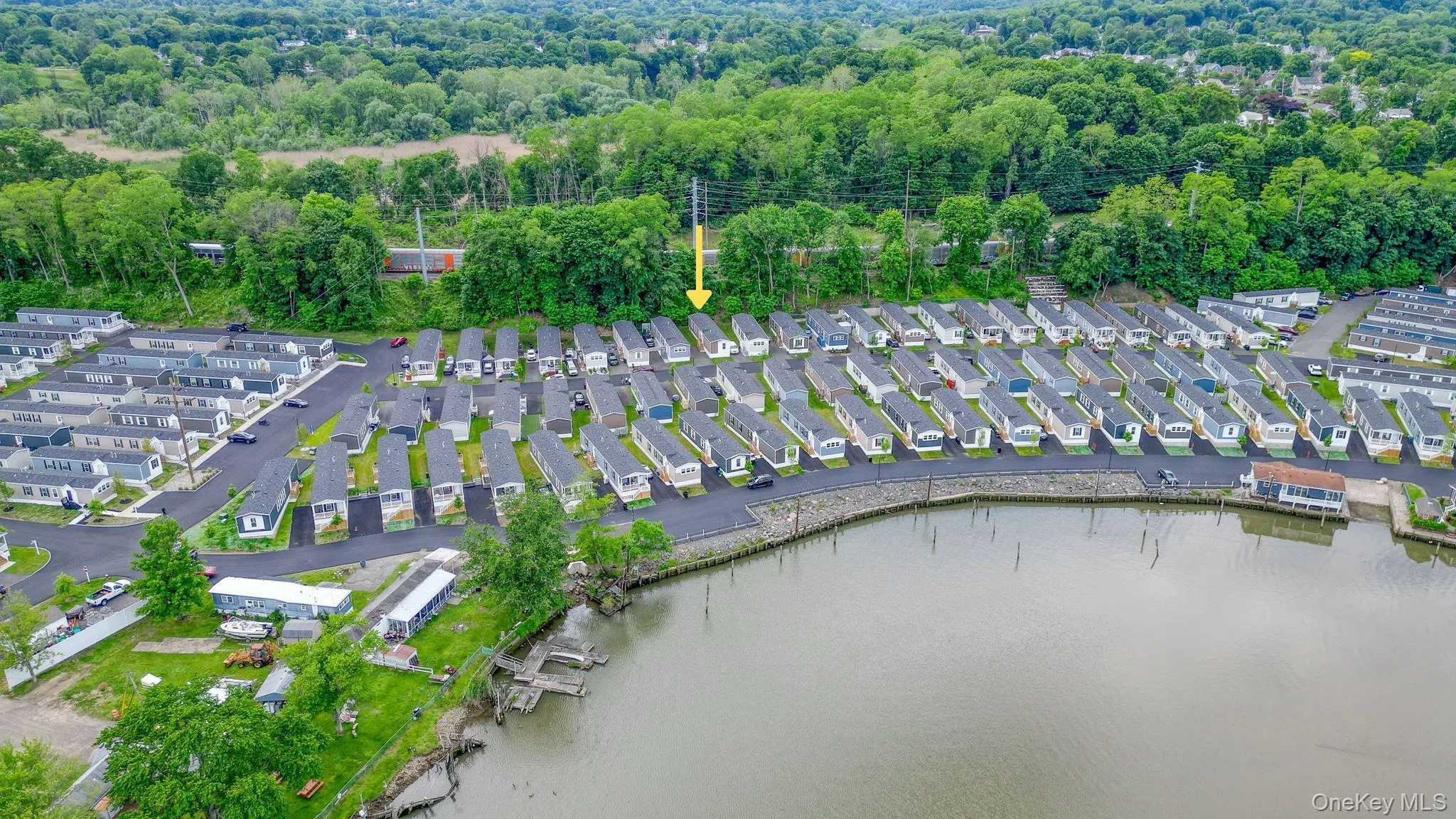 Waterfront property featuring a residential community with paved roadways and individual homes Waterfront property featuring a residential community with paved roadways and individual homes