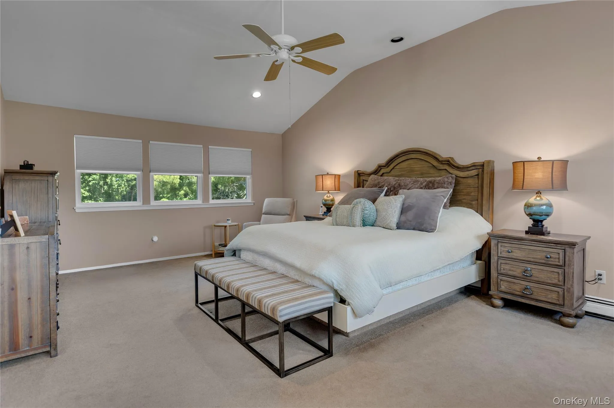 Vaulted ceiling bedroom with soft neutral carpeting and recessed lighting Vaulted ceiling bedroom with soft neutral carpeting and recessed lighting
