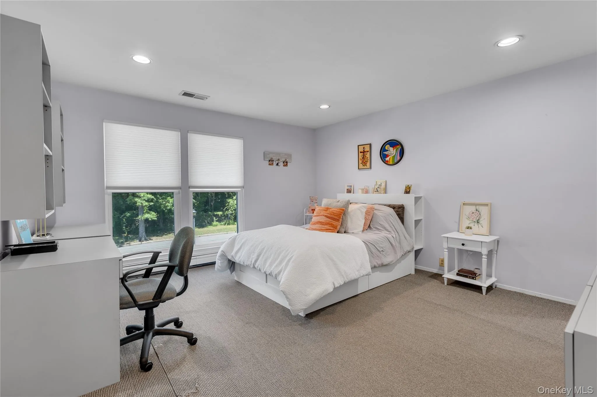 Spacious room featuring neutral carpeting, recessed lighting, and dual windows with privacy blinds Spacious room featuring neutral carpeting, recessed lighting, and dual windows with privacy blinds