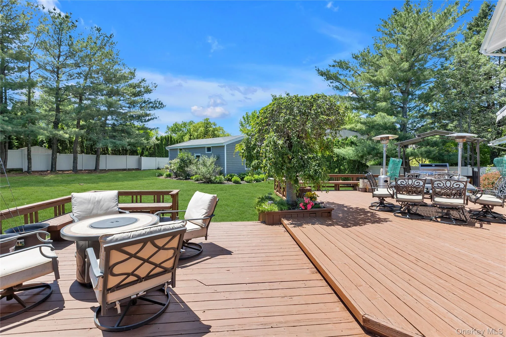 Spacious outdoor deck featuring natural wood flooring and railing Spacious outdoor deck featuring natural wood flooring and railing