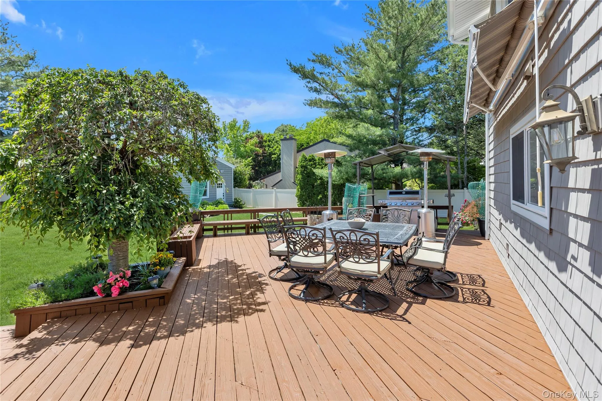 Expansive wood deck with built-in planters and bench seating Expansive wood deck with built-in planters and bench seating