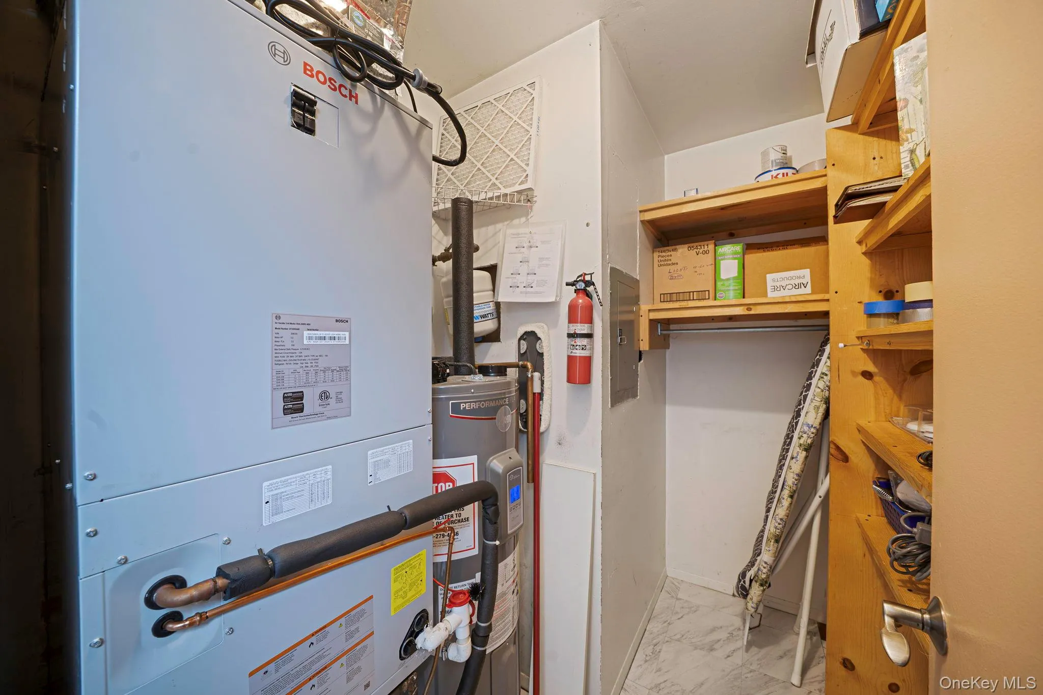 Utility room with newly installed BOSCH HVAC system, RHEEM water heater and plenty of space for storage with shelving built in. Utility room with newly installed BOSCH HVAC system, RHEEM water heater and plenty of space for storage with shelving built in.