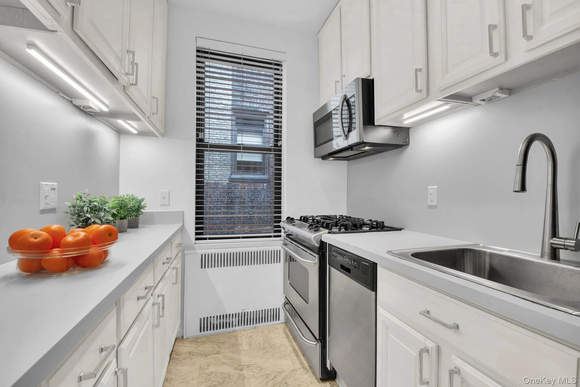 Abundant cabinet space with window and stainless steel appliances Abundant cabinet space with window and stainless steel appliances