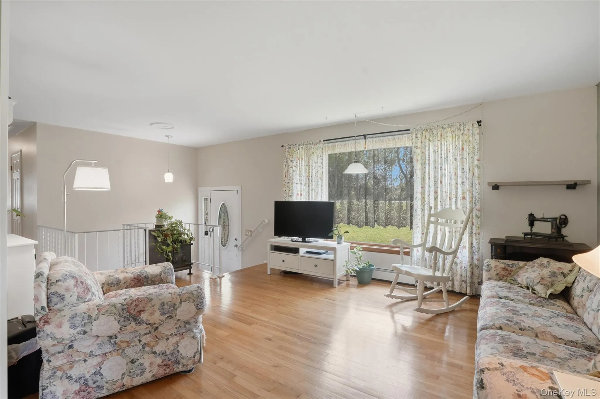 Wood floors and large window in your spacious living room. Entertaining, friendly chats, or just relaxing ~ this space is perfect! Wood floors and large window in your spacious living room. Entertaining, friendly chats, or just relaxing ~ this space is perfect!
