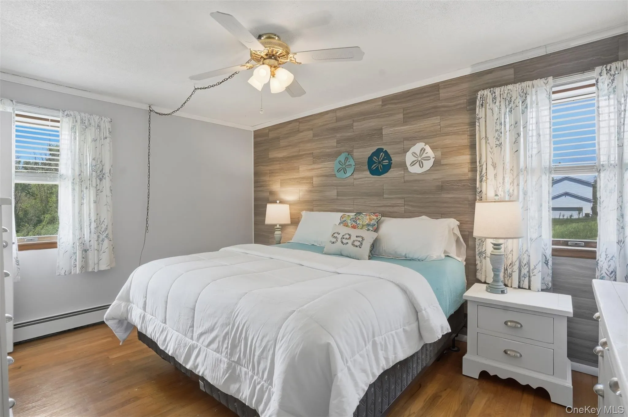 Primary en-suite with wood floors, walk-in closet, ceiling fan Primary en-suite with wood floors, walk-in closet, ceiling fan