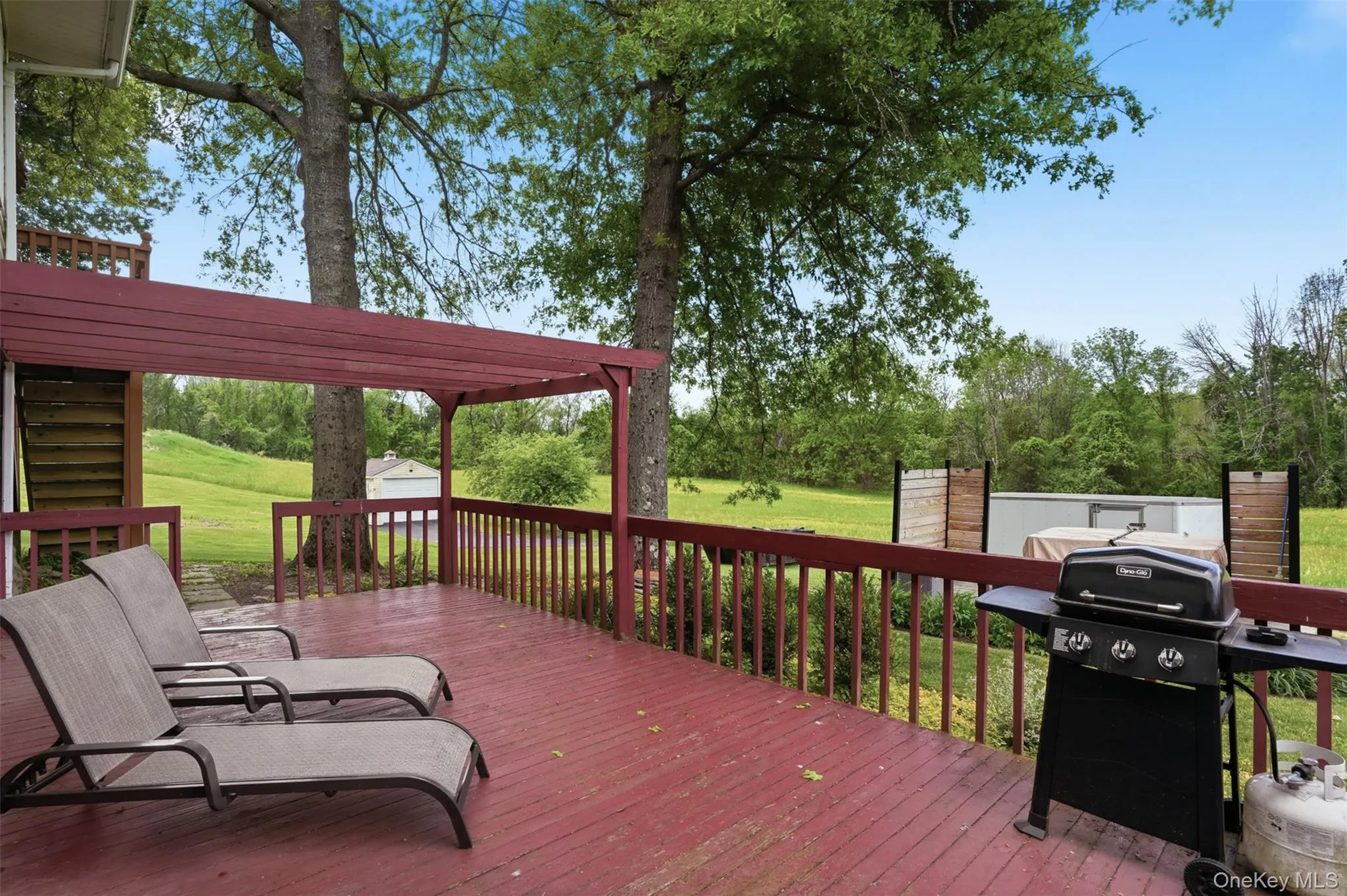 Accessed from the lower level, this deck is perfect for summer barbecues or relaxing with a book and beverage Accessed from the lower level, this deck is perfect for summer barbecues or relaxing with a book and beverage