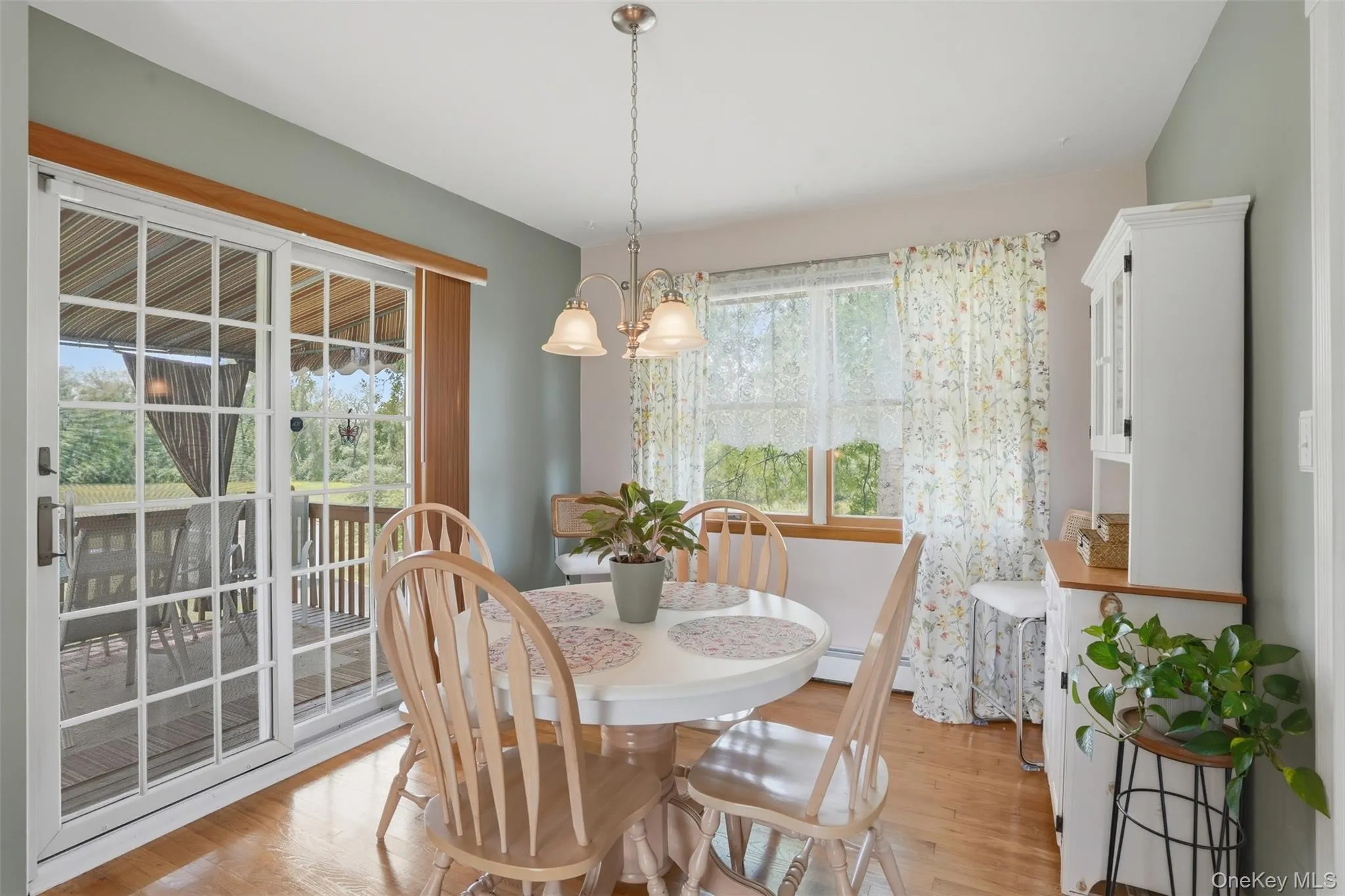 Open to the living room, the dining area has sliding doors that lead to a deck with awning ~ a perfect extension for eating and al fresco dining. Open to the living room, the dining area has sliding doors that lead to a deck with awning ~ a perfect extension for eating and al fresco dining.