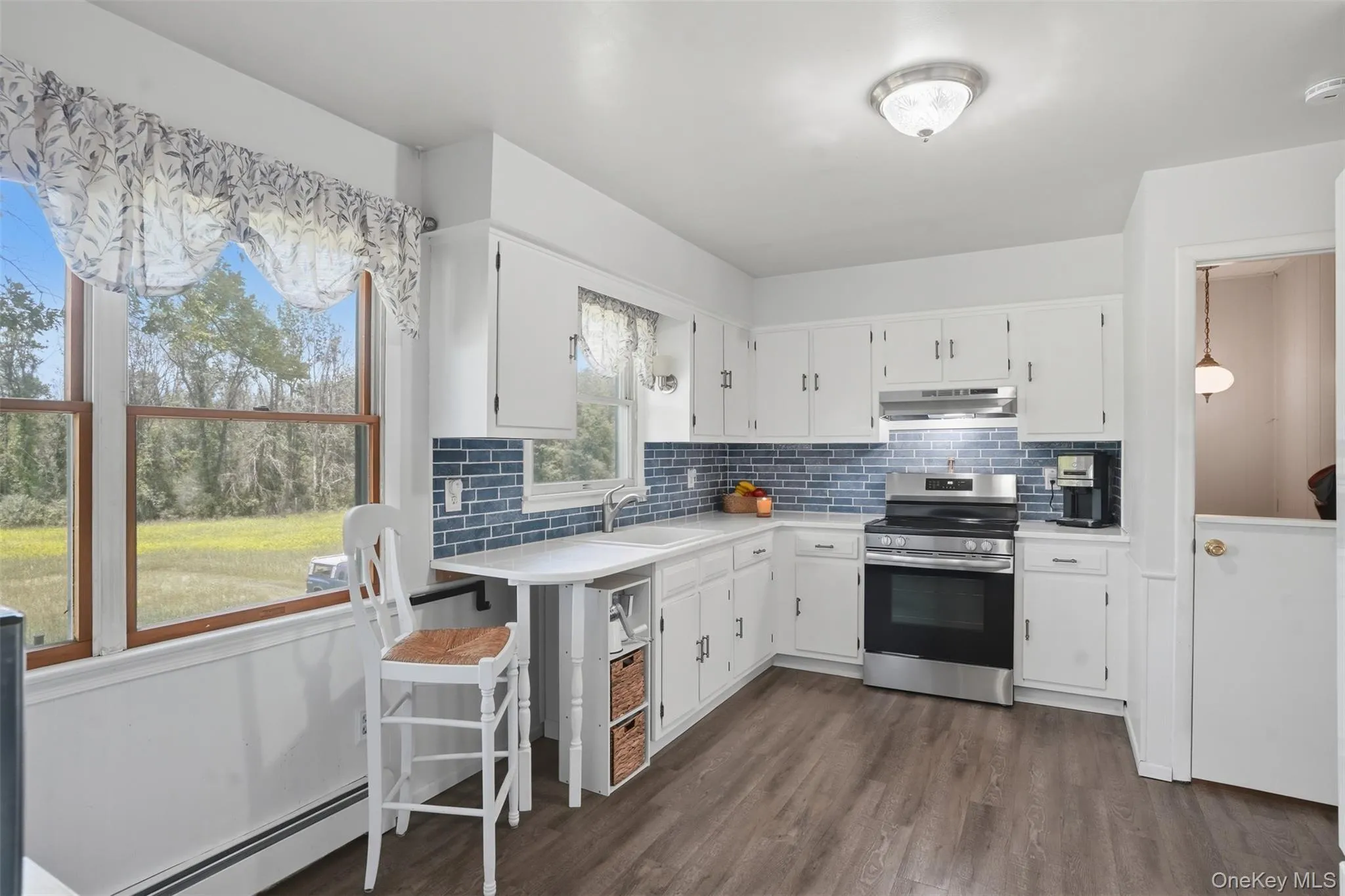 Recently refreshed, your kitchen has quartz counters, glass tile backsplash, newer appliances, and timeless white cabinetry. Recently refreshed, your kitchen has quartz counters, glass tile backsplash, newer appliances, and timeless white cabinetry.