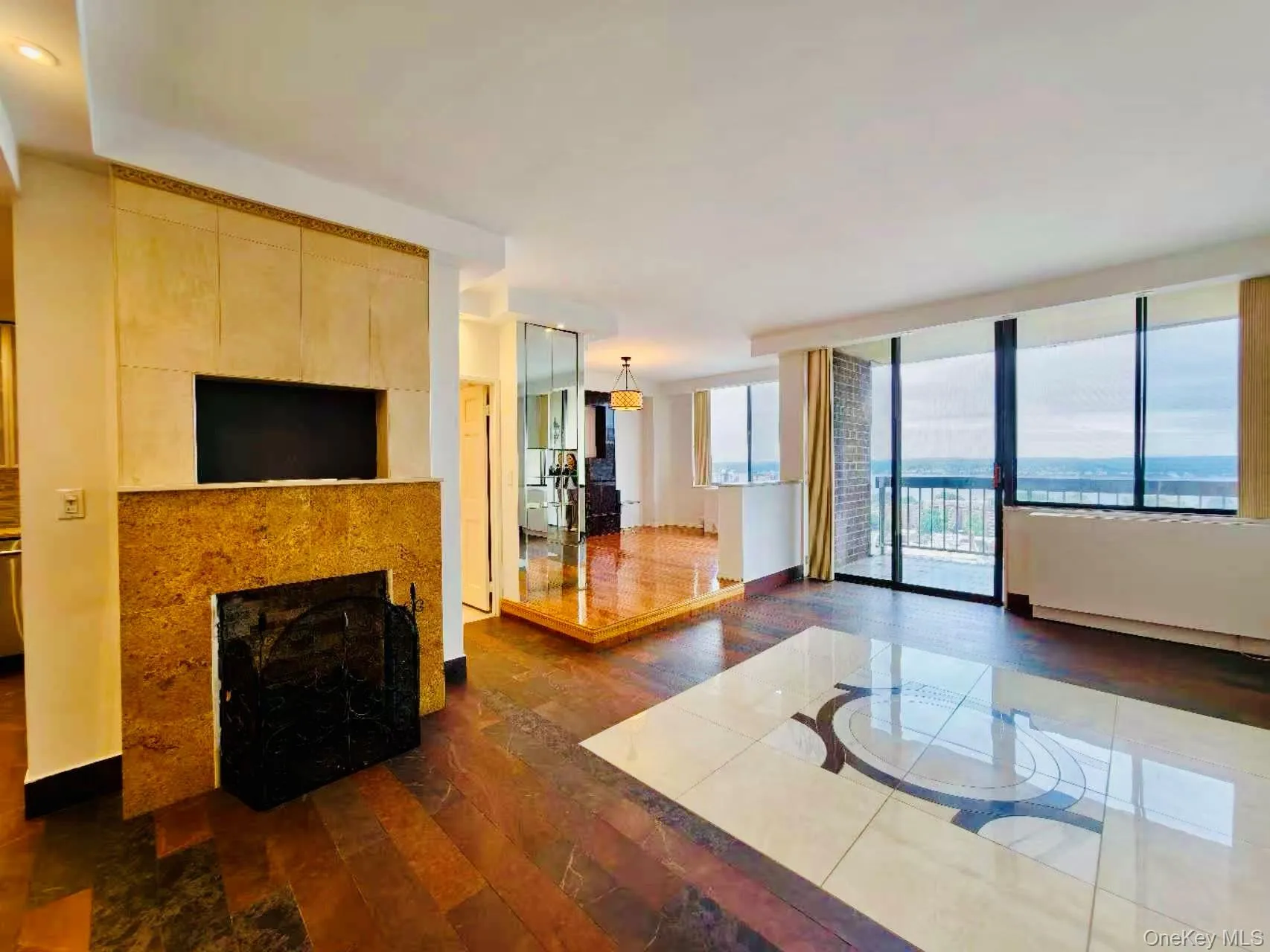Living area featuring dark wood-style floors, a fireplace, and floor to ceiling windows Living area featuring dark wood-style floors, a fireplace, and floor to ceiling windows