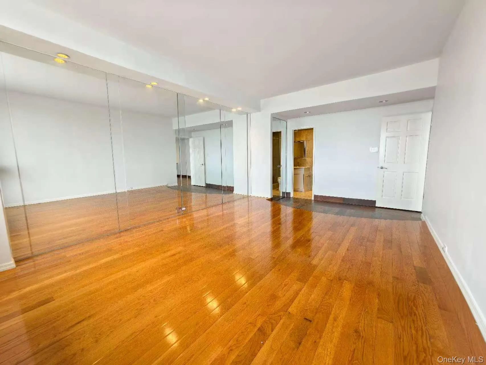 Spare room with wood finished floors and baseboards Spare room with wood finished floors and baseboards