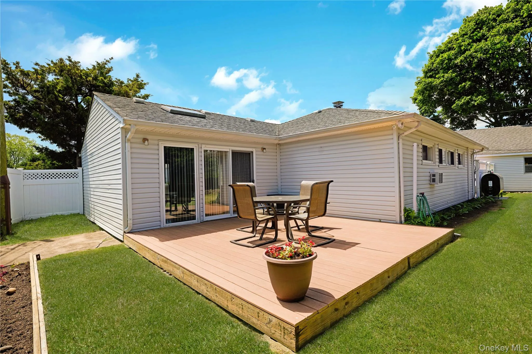 View of Entertainers Deck with Sliders from Dining Room leading to Yard. View of Entertainers Deck with Sliders from Dining Room leading to Yard.