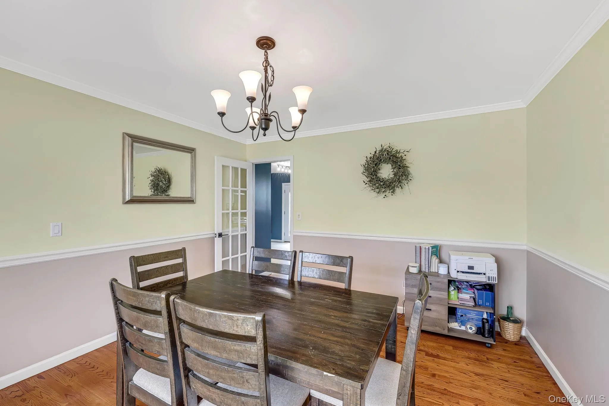 Alternate view of the formal dining room with crown molding and glass window pane doors for privacy. Alternate view of the formal dining room with crown molding and glass window pane doors for privacy.